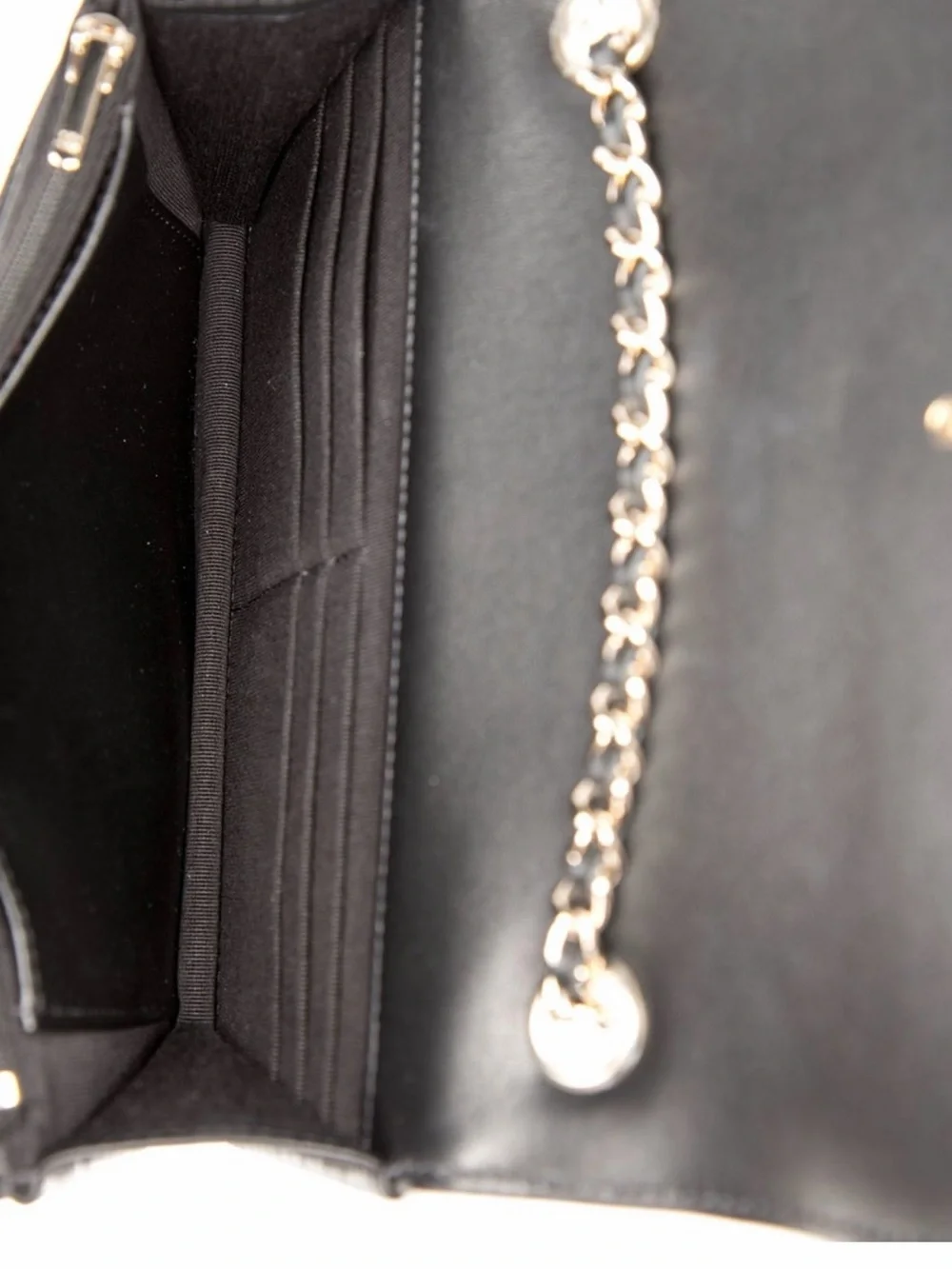 CHANEL Black Quilted Leather Shoulder Bag with White Trim and Gold Chain